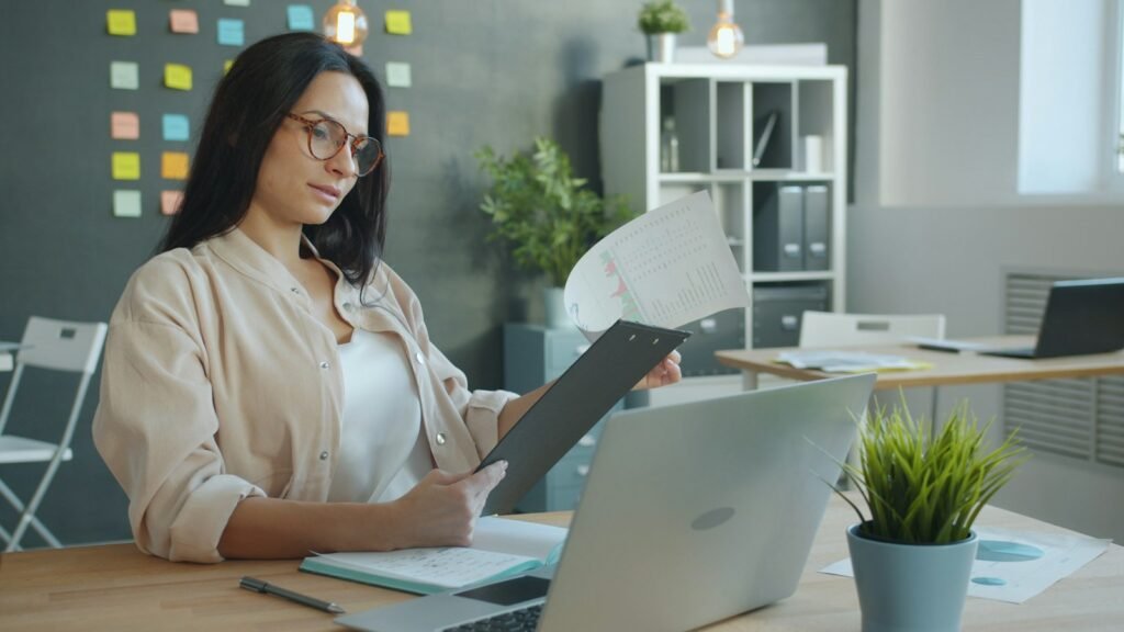HR professional reviewing information at a laptop