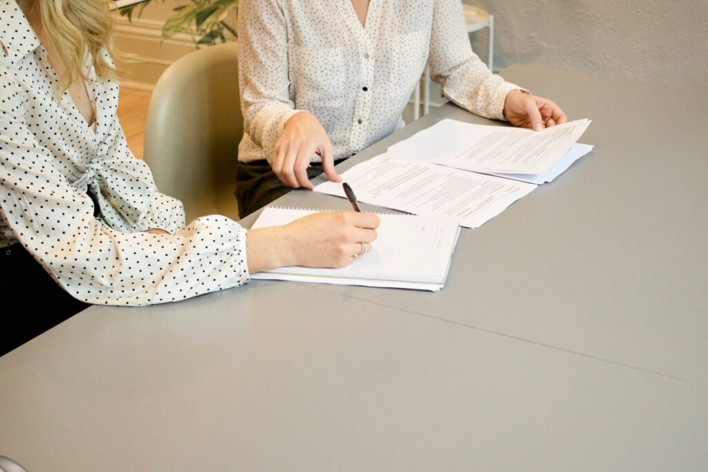 Legal professionals reviewing and signing documents in an office