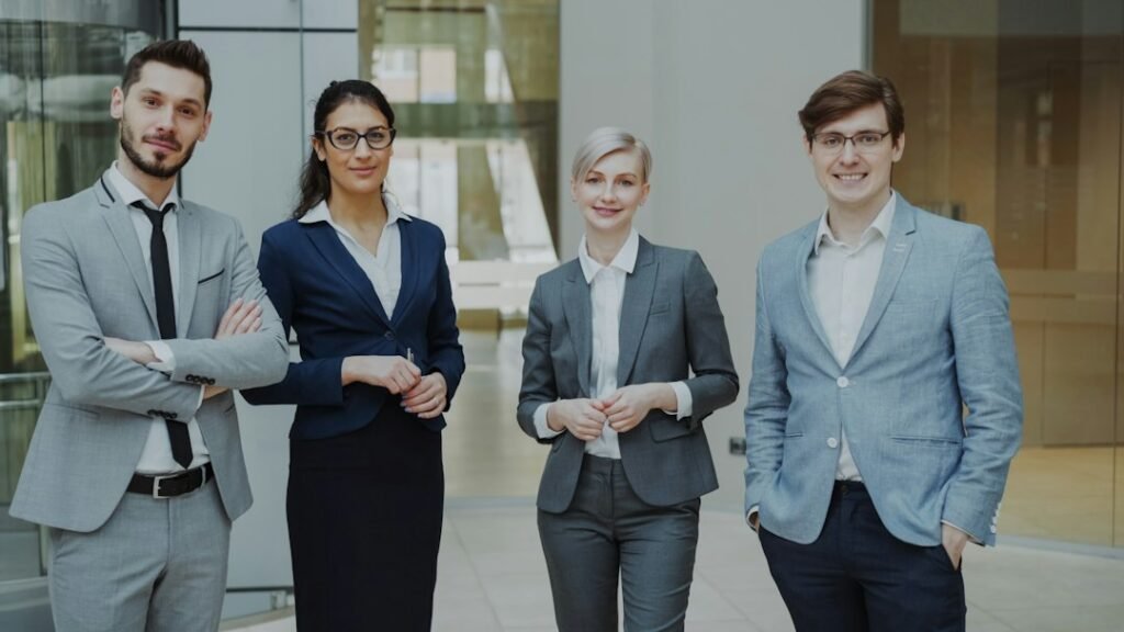 A diverse team of business professionals standing together in a modern office